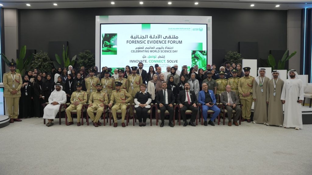 Audience seated among student project displays at the Forensic Science Forum